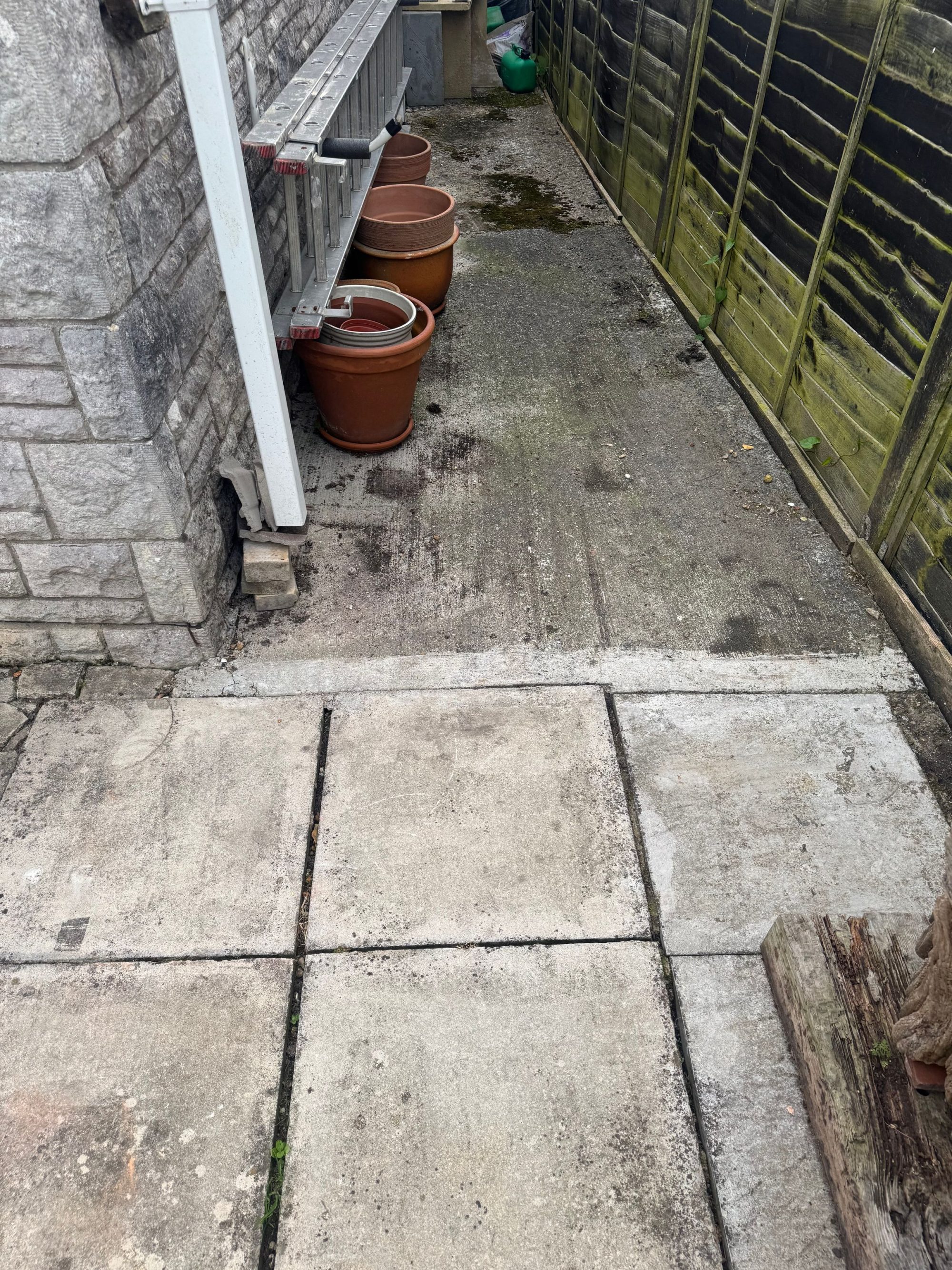 Garden alley before pressure washing in Weymouth